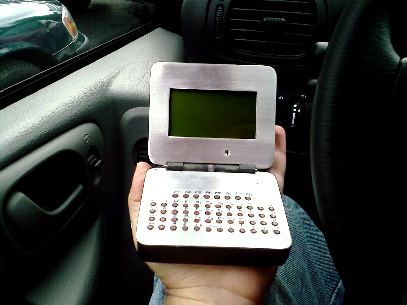 Silver-front Sirius prototype held open in a car